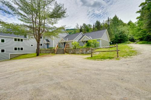 a home with a driveway and a house at Ski-InandSki-Out Magic Mountain Condo with Deck! in Londonderry