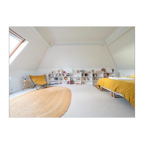 une chambre avec un lit et une table dedans dans l'établissement Maison Hestia, à Épégard