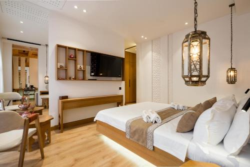 a bedroom with a white bed and a desk at Sarhad Hotel in Bukhara