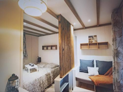 a bedroom with a bed and a large mirror at Domaine Le Jardin de Séraphine in Malleville-les-Grès
