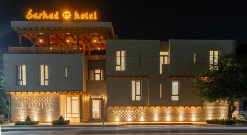 a building with lights in front of it at night at Sarhad Hotel in Bukhara
