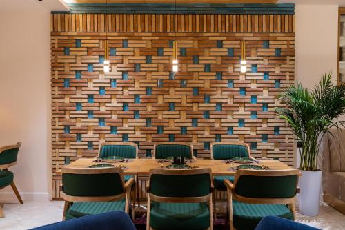 a conference room with a table and chairs against a brick wall at Sarhad Hotel in Bukhara