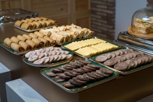 a buffet of different types of donuts and other pastries at Sarhad Hotel in Bukhara