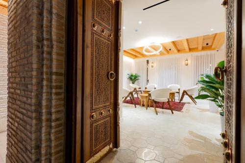 an open door into a dining room with a table at Sarhad Hotel in Bukhara