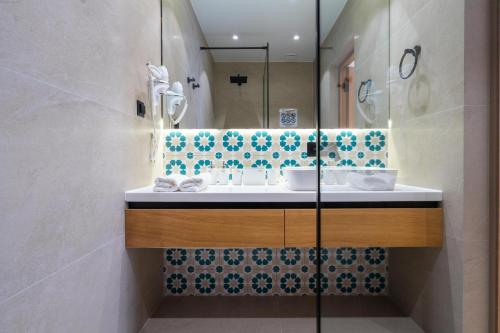 a bathroom with a sink and a mirror at Sarhad Hotel in Bukhara