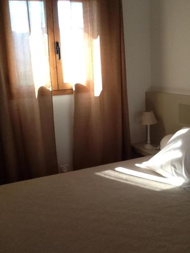 - une chambre avec un lit, une fenêtre et un couvre-lit dans l'établissement jolie location, à Porto-Vecchio
