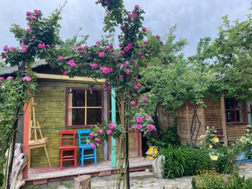 a small house with two chairs and flowers at Philosophy Hotel in Uchisar