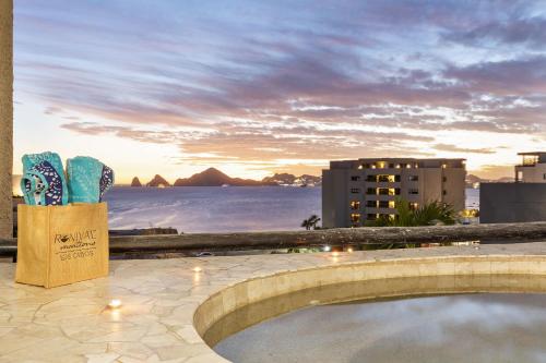 a view of the ocean from a resort with a pool at Stunning 2 BR with Ocean Views & Jacuzzi by the Beach in Cabo San Lucas