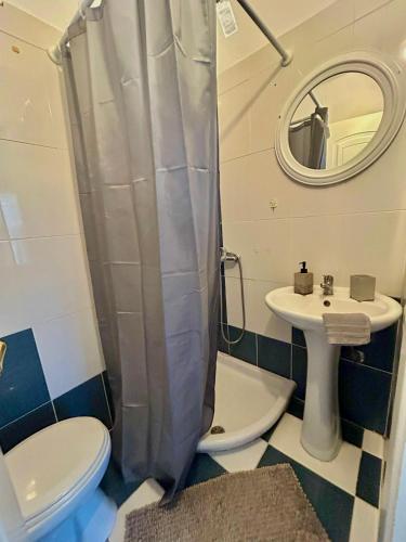 a bathroom with a toilet and a sink at Cozy apartment comfy 1 in Serres