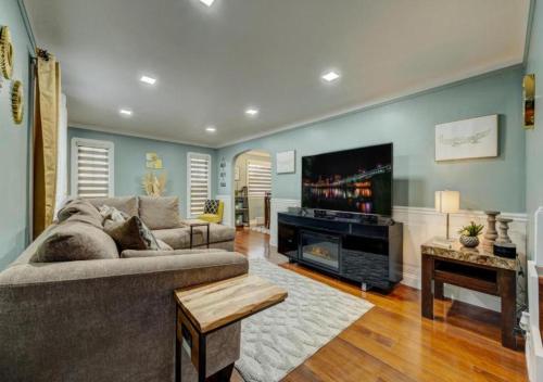 a living room with a couch and a tv at South Euclid Home 10 Minutes to Cleveland Clinic in South Euclid
