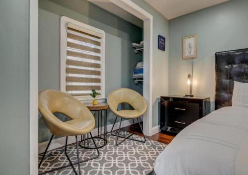 a bedroom with two chairs and a bed and a window at South Euclid Home 10 Minutes to Cleveland Clinic in South Euclid