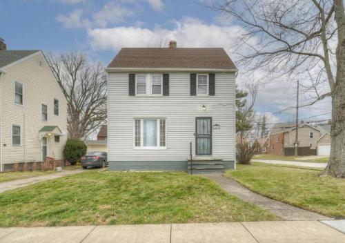 a white house with a porch on a street at South Euclid Home 10 Minutes to Cleveland Clinic in South Euclid