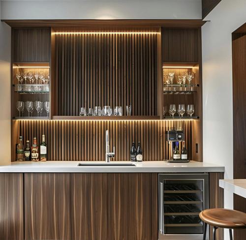 a kitchen with a sink and a counter with wine glasses at The Hide Out in Belfast
