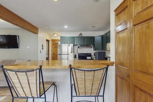 a kitchen with two chairs at a counter at Ore House 8 in Frisco