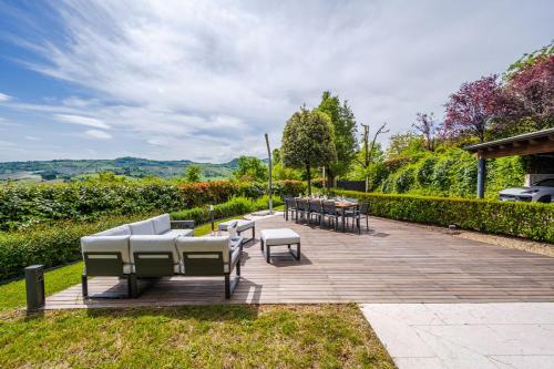 a patio with couches and chairs and tables at Residenza Storica sulle Colline di Maranello in Fogliano