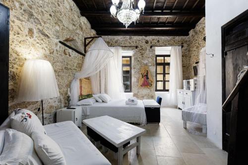 a bedroom with two beds and a chandelier at Antonia's House - Old town in Rethymno