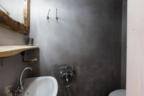 a bathroom with a sink and a toilet at Antonia's stonebuilt mansion with a private pool in Arménoi