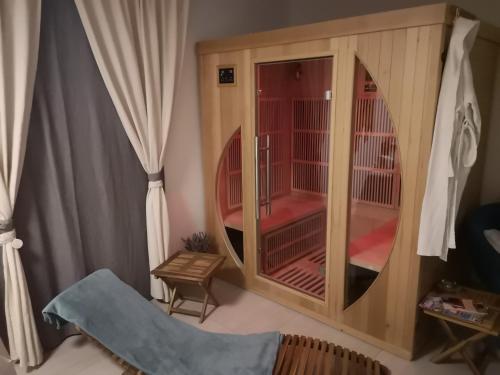 a bird cage in a living room with a window at Apartments Ole in Tolmin