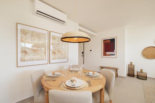 a dining room with a wooden table and chairs at Flamingos Salgados in Albufeira