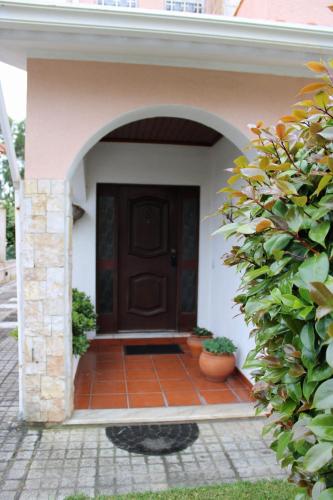 a front door of a house with a brick walkway at JP Guest House in Aveiro