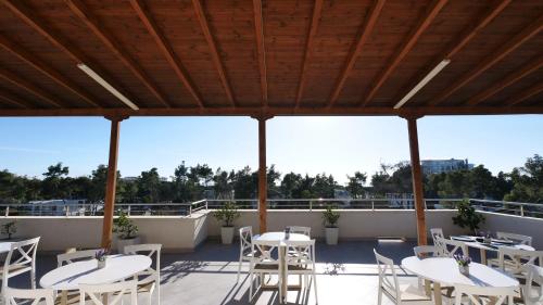 a patio with white tables and chairs on a roof at Vila Duro in Golem