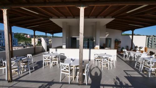a group of tables and chairs on a rooftop patio at Vila Duro in Golem