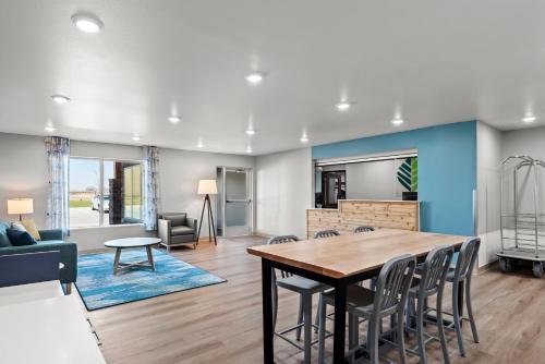 a dining room and living room with a table and chairs at WoodSpring Suites Coralville Iowa City in Coralville