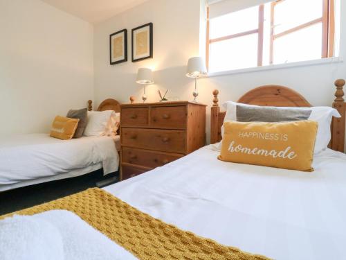 a bedroom with two beds and a dresser at BB House in Bedford