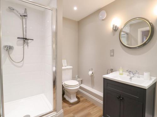 a bathroom with a shower and a toilet and a sink at BB House in Bedford
