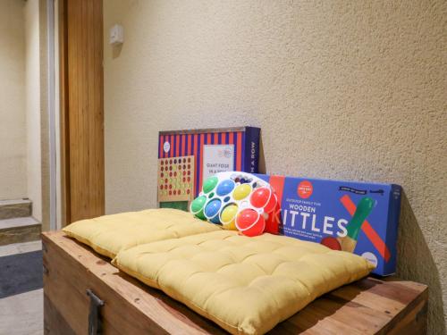 a mattress with books and a ball on top of it at BB House in Bedford