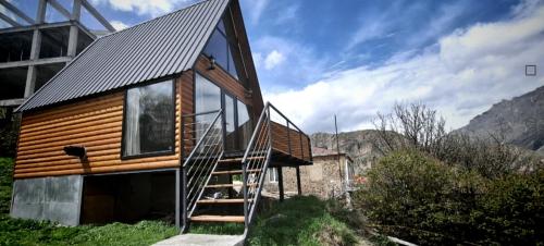 a house with a metal roof and a staircase at My house in Stepantsminda