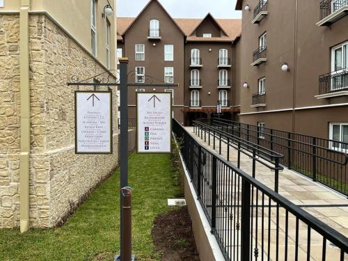 a sign in the grass next to a building at GRAMADO BUONA VITTA RESORT Spa in Gramado
