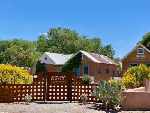 a fence with astay sign in front of a house at Stay Old Town Road in Albuquerque