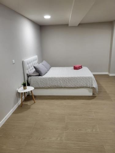 a white room with a bed and a table at Alicante 10 in Alicante