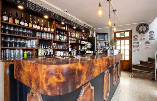 a bar with a rusty counter in a room at Hôtel du Centre - Le restaurant in Meursault