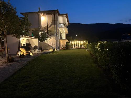 a large house with a lawn in front of it at La Casa Tzortzina in Kókkinon Nerón