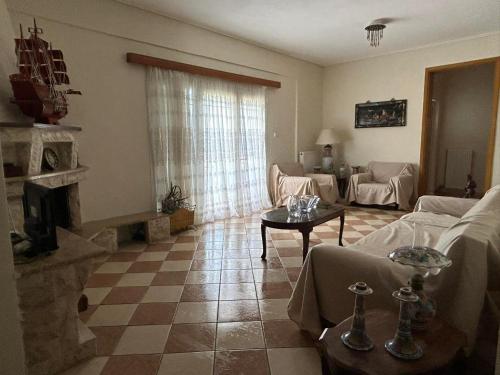 a living room with a couch and a table at La Casa Tzortzina in Kókkinon Nerón