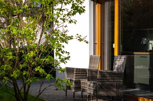 a group of chairs sitting on a patio at Deluxe apartments Bled in Bled