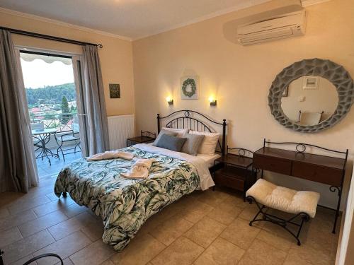 a bedroom with a bed and a mirror and a table at Iremia in Kariá