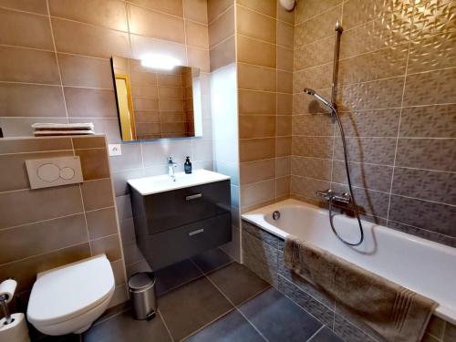 une salle de bain avec une baignoire, des toilettes et un lavabo dans l'établissement Appartement spacieux avec jardin privatif, 3 chambres, Les Gets - Multipass été 2024 inclus - FR-1-598-63, aux Gets