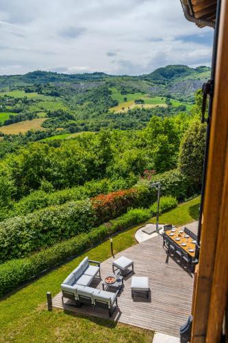 a patio with a table and chairs and a view at Residenza Storica sulle Colline di Maranello in Fogliano