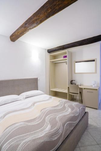 a bedroom with a large bed and a desk at OltreMare in Riomaggiore