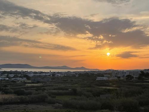 a view of a city with the sunset in the background at Philia villas in Agkidia