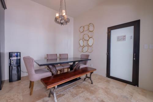 a dining room with a table and a chair at Diamante Beachfront Suites in San Pedro