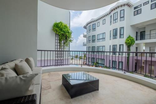 a living room with a couch and a building at Diamante Beachfront Suites in San Pedro