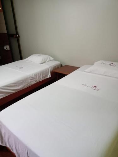Postel nebo postele na pokoji v ubytování FlorD'Lis-Hospedaje en el centro de Moyobamba