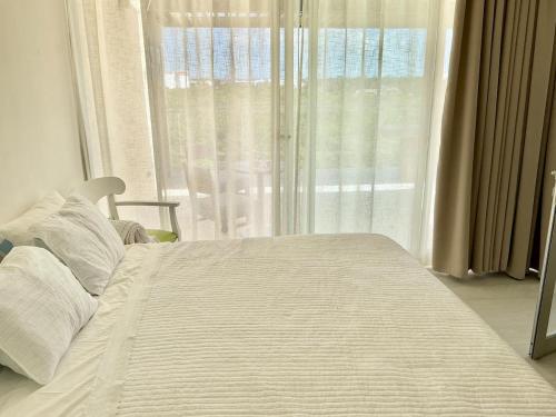 a bedroom with a bed and a window with a view at Vibe Residence Gorgeous Penthouse with Jacuzzi & outstanding Sea & Natural Preserve view in La Laguna