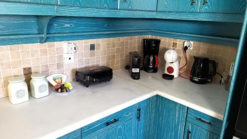 a kitchen counter with various appliances on a counter top at Villa Golden Sun with swimming pool and jacuzzi in Anavissos
