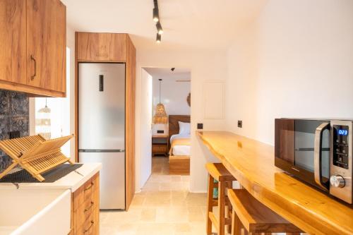 a kitchen with a counter top and a refrigerator at Villa Zina Sunset View St Lazaros 7 plus 1 Bedroom in Psarou