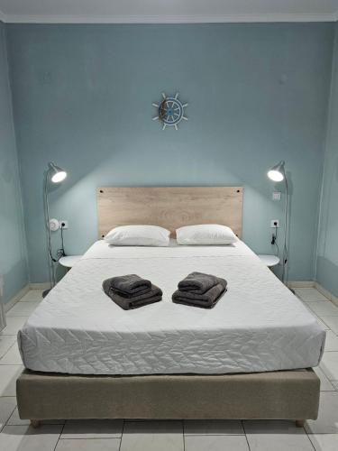 a bedroom with a bed with two towels on it at Katerina Apartments in Kato Daratso
